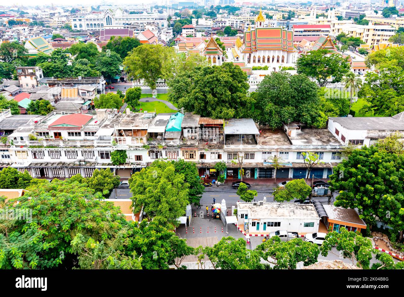 Panorama view of Bangkok city, Thailand. Cityscape of residental buildings in foreground, temples, skyscrapers and modern buildings in far. Fresh tree Stock Photo