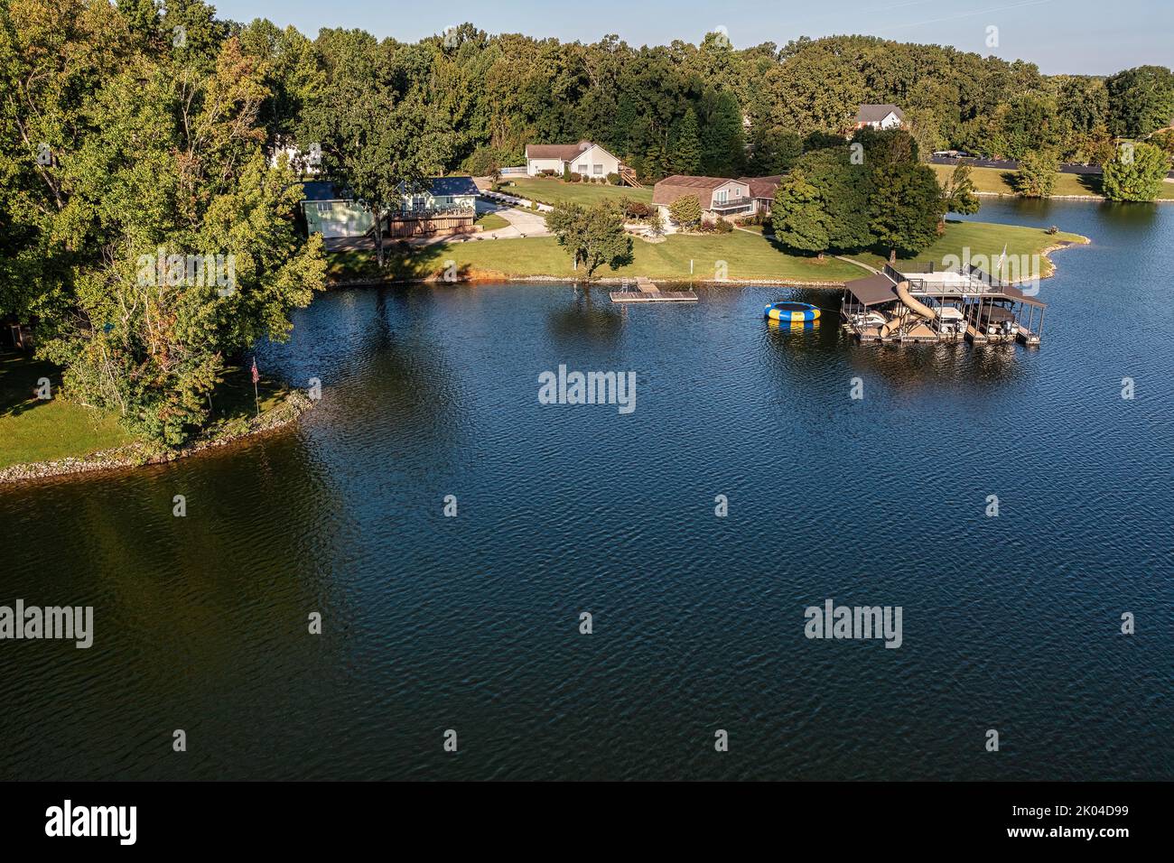 Aerial view of lakefront homes and floating boat docks with upper deck
