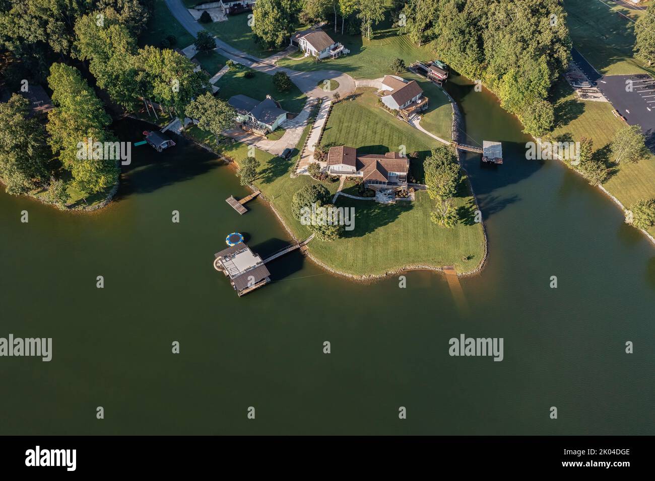 Aerial overhead view of lakefront homes and floating boat docks with