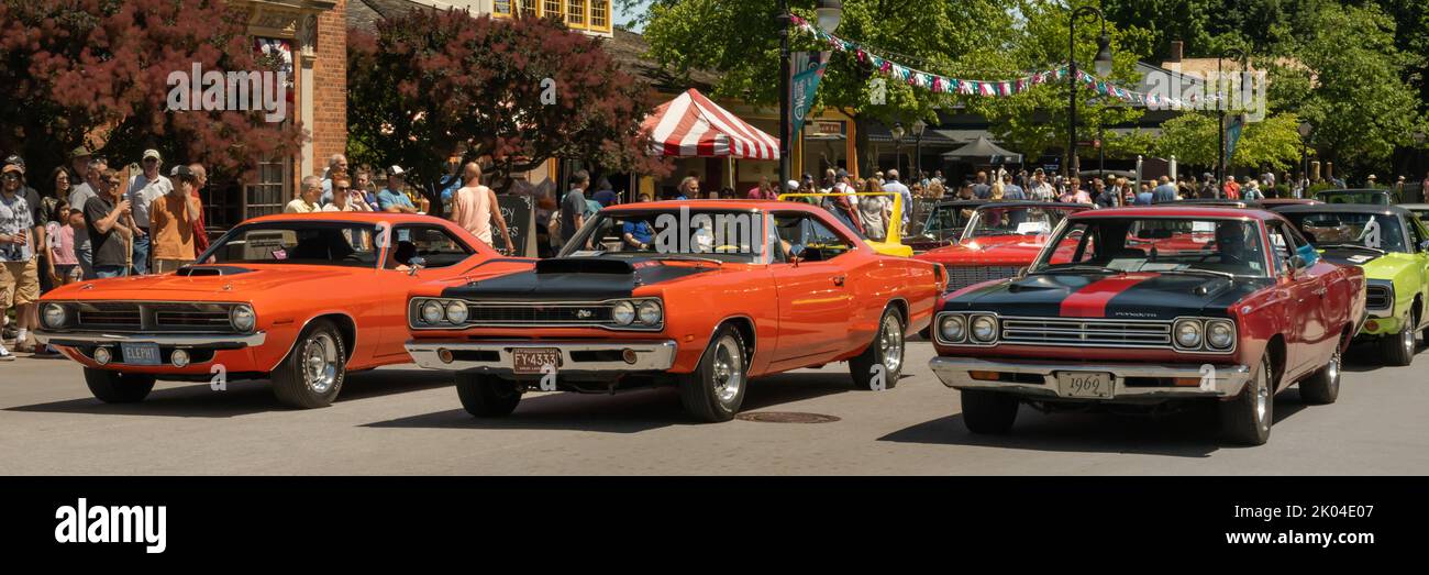 DEARBORN, MI/USA - JUNE 18, 2022: Muscle car parade at the Henry Ford (THF) Motor Muster car show, held at Greenfield Village, near Detroit, Michigan. Stock Photo