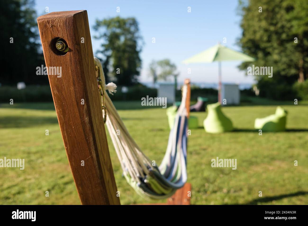 Empty multi-colored hammock on wooden stands, on a warm summer sunny day.  Stock Photo