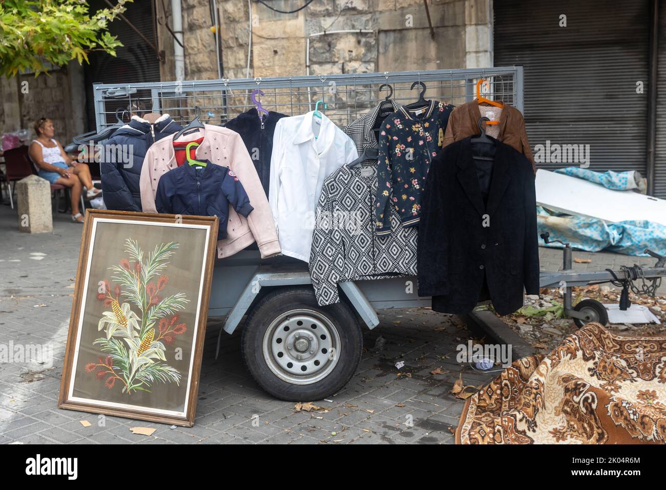 Haifa, Israel - June 30, 2022, various women's and men's jackets and jackets hanging on a rail for sale at a flea market Stock Photo