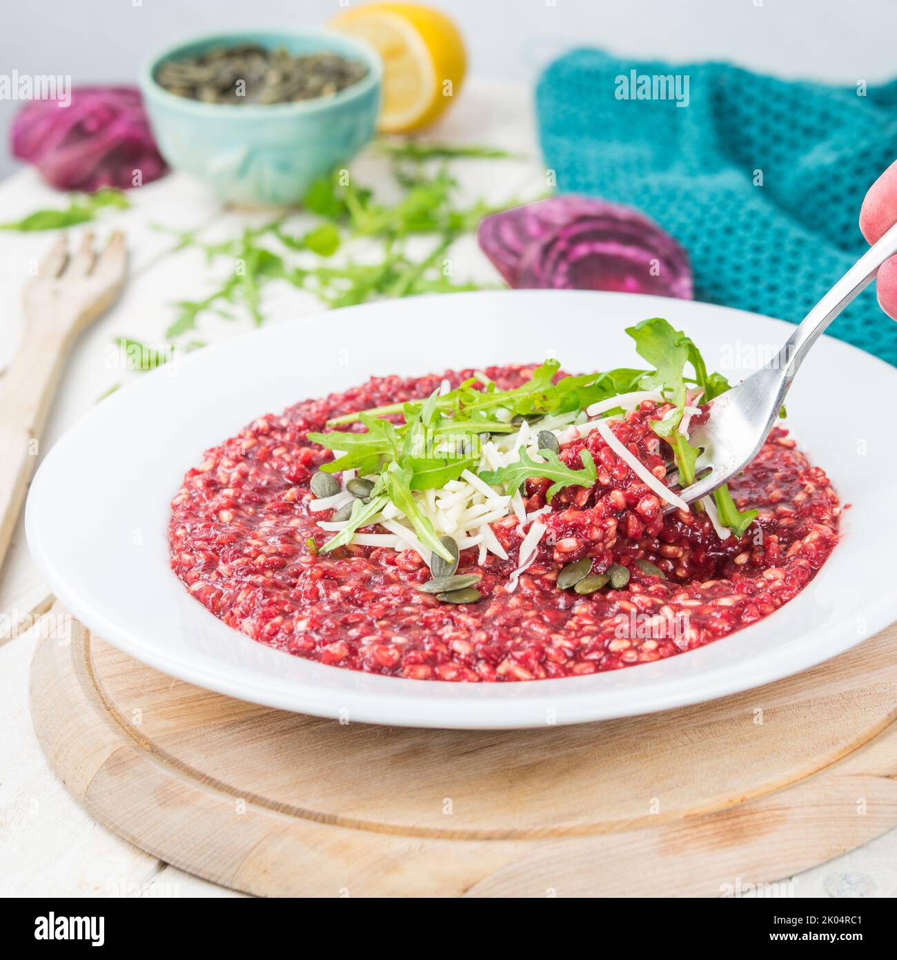 Vegan food, cream beetroot risotto decorated with vegan cheese, pumpkin