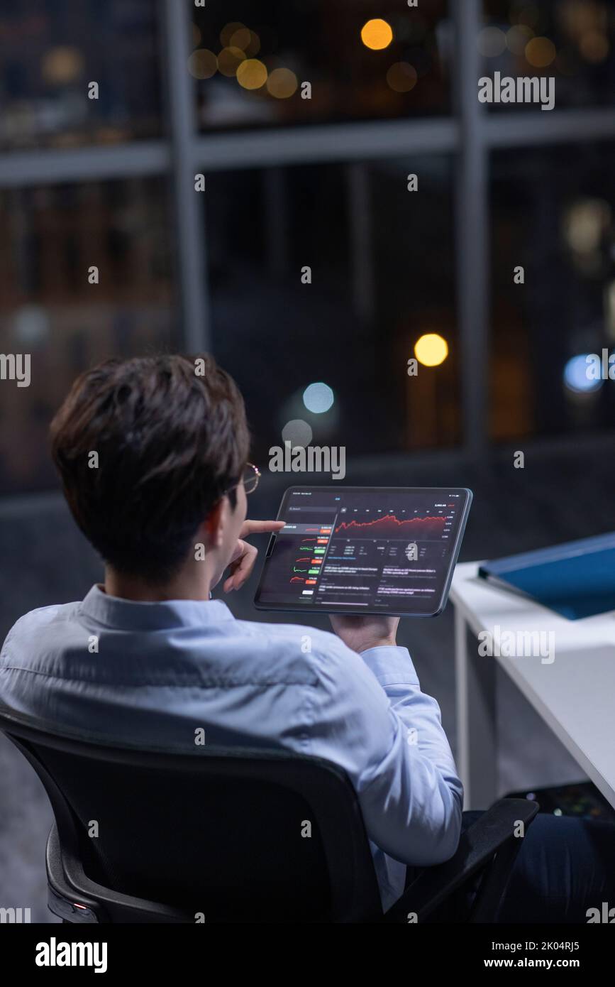 Chinese businessman working in office at night Stock Photo