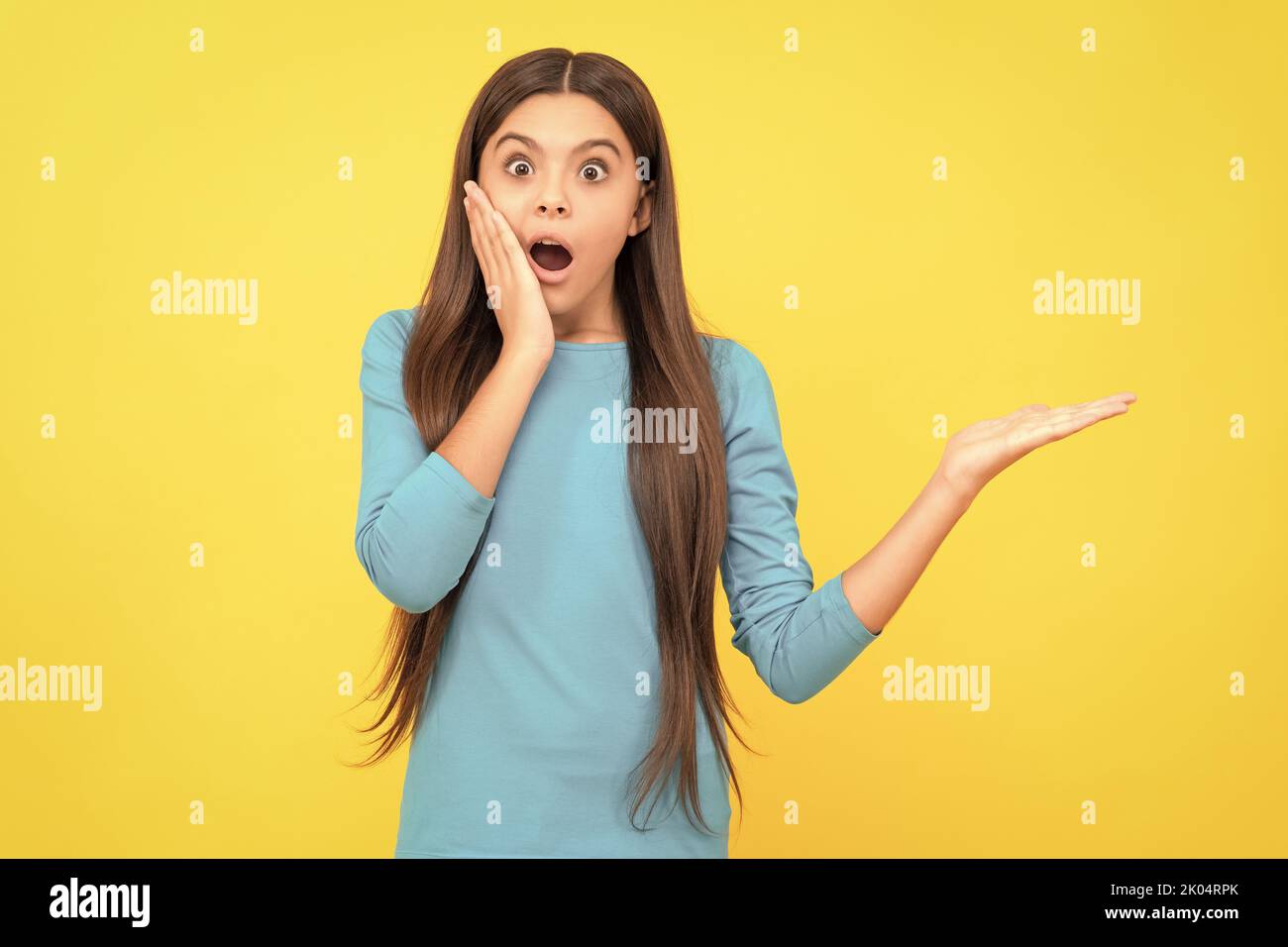 shocked face portrait of child on yellow background. express positive ...