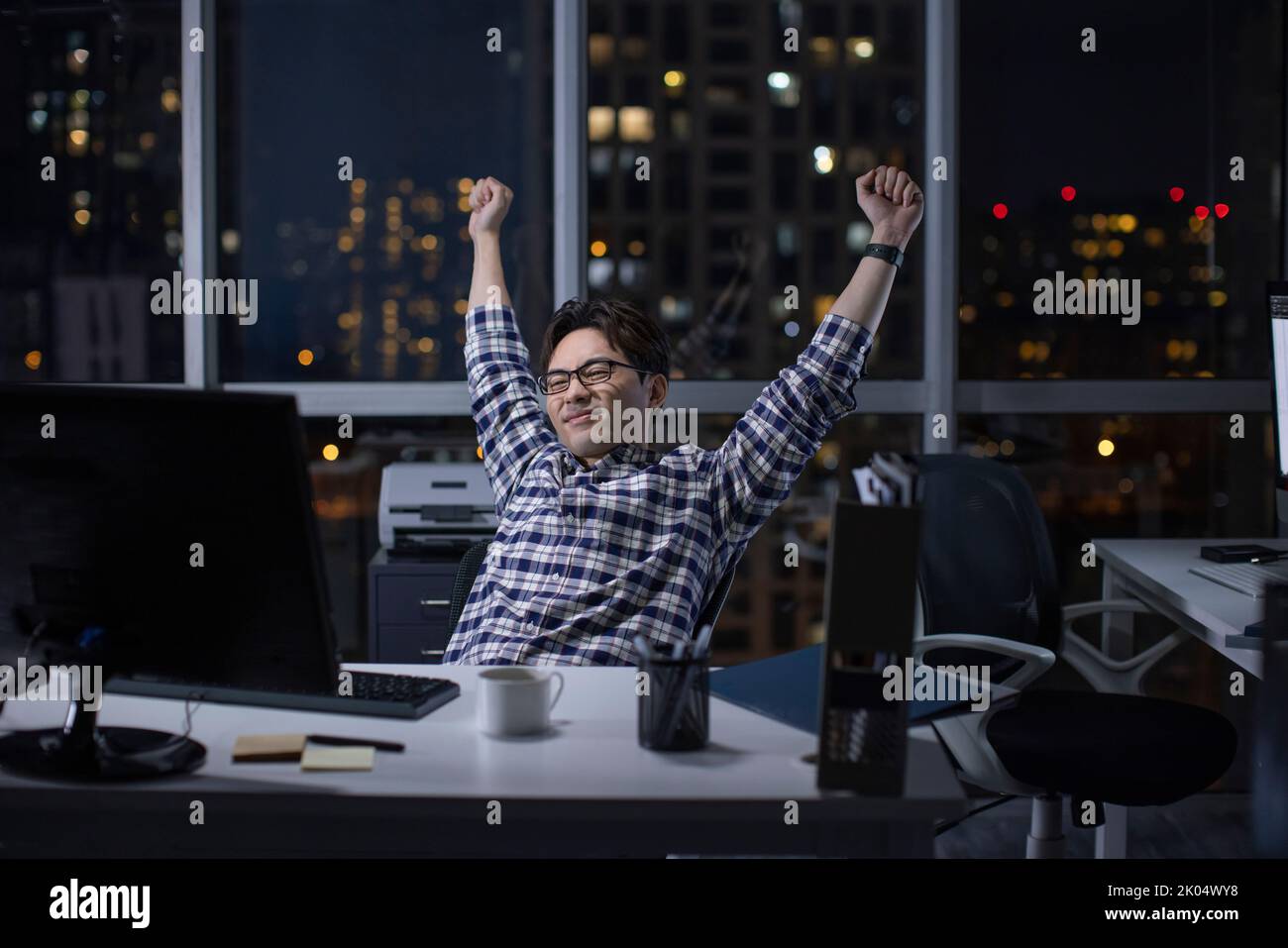 Chinese IT worker working in office at night Stock Photo