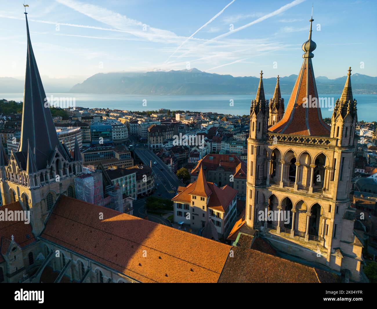August 22nd 2022, Lausanne, Switzerland. A drone aerial shot of Lausanne cathedral and majestic Lake Geneva at sunrise. Stock Photo