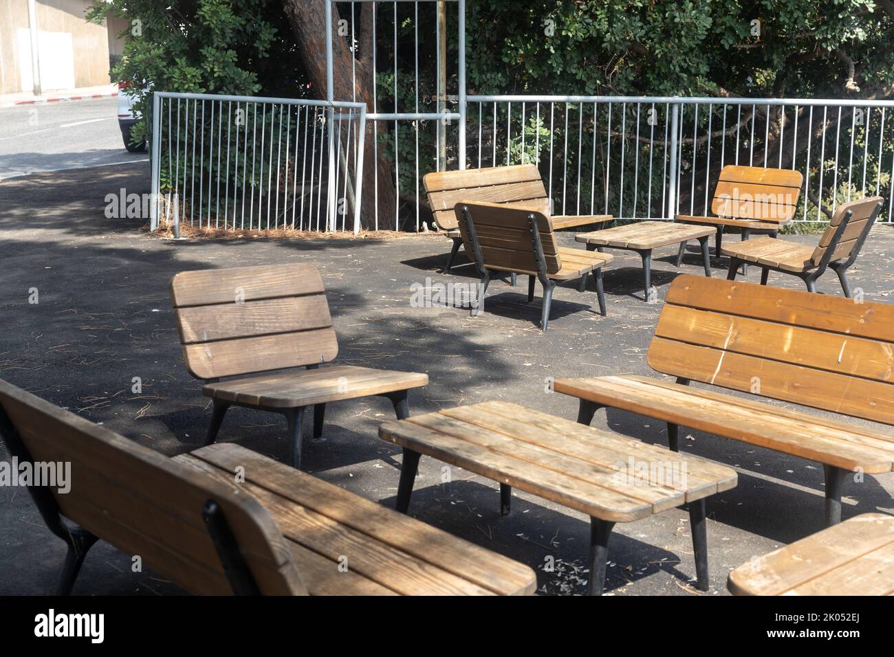 wooden modern benches and tables in the park in the recreation area Stock Photo