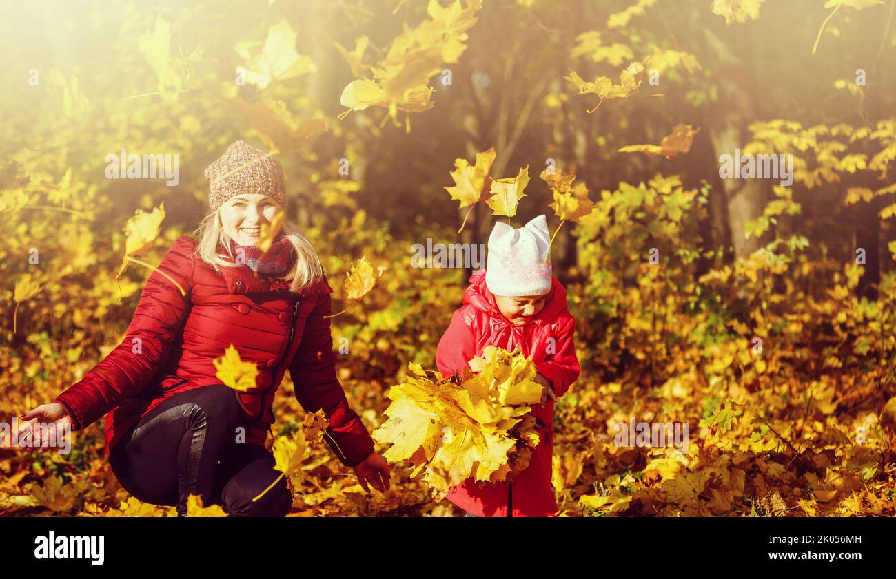 Young mother playing with her daughter in autumn park Stock Photo - Alamy
