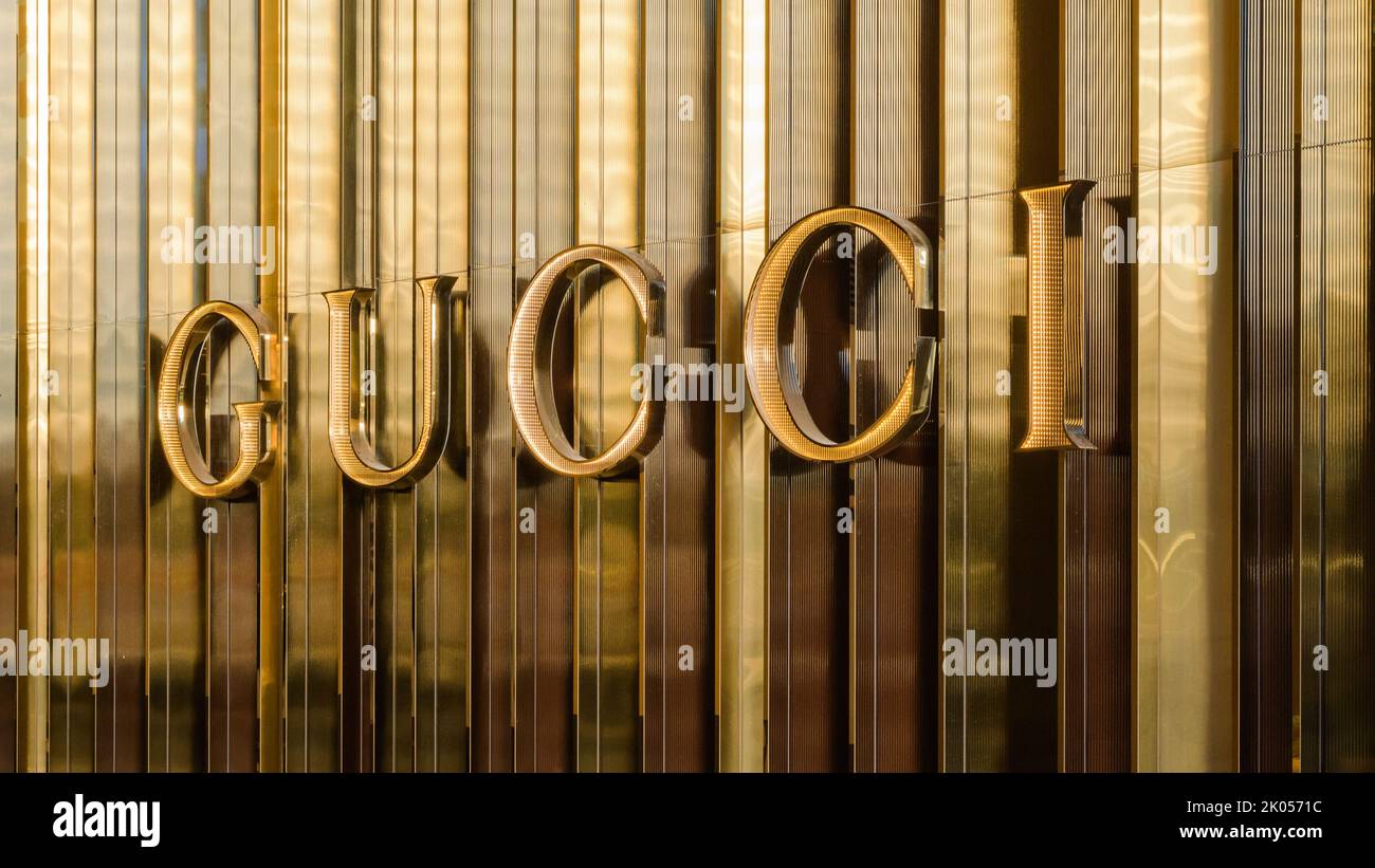 Bellevue, WA, USA - September 08, 2022; Luxury brand Gucci name spelt out on a gold wall in close up Stock Photo