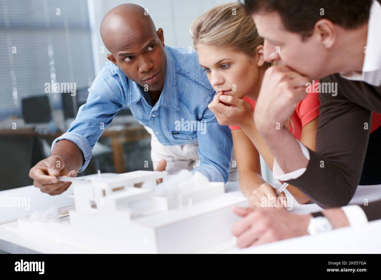 Innovative designers at work. A team of architects looking thoughtful ...