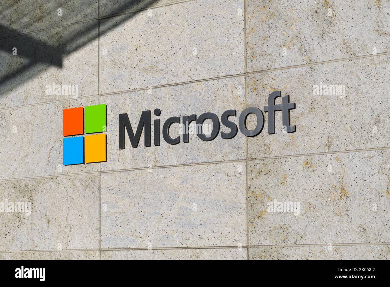 Bellevue, WA, USA - September 08, 2022; Sign for Microsoft Corporation with logo on stone tile wall with shadow Stock Photo
