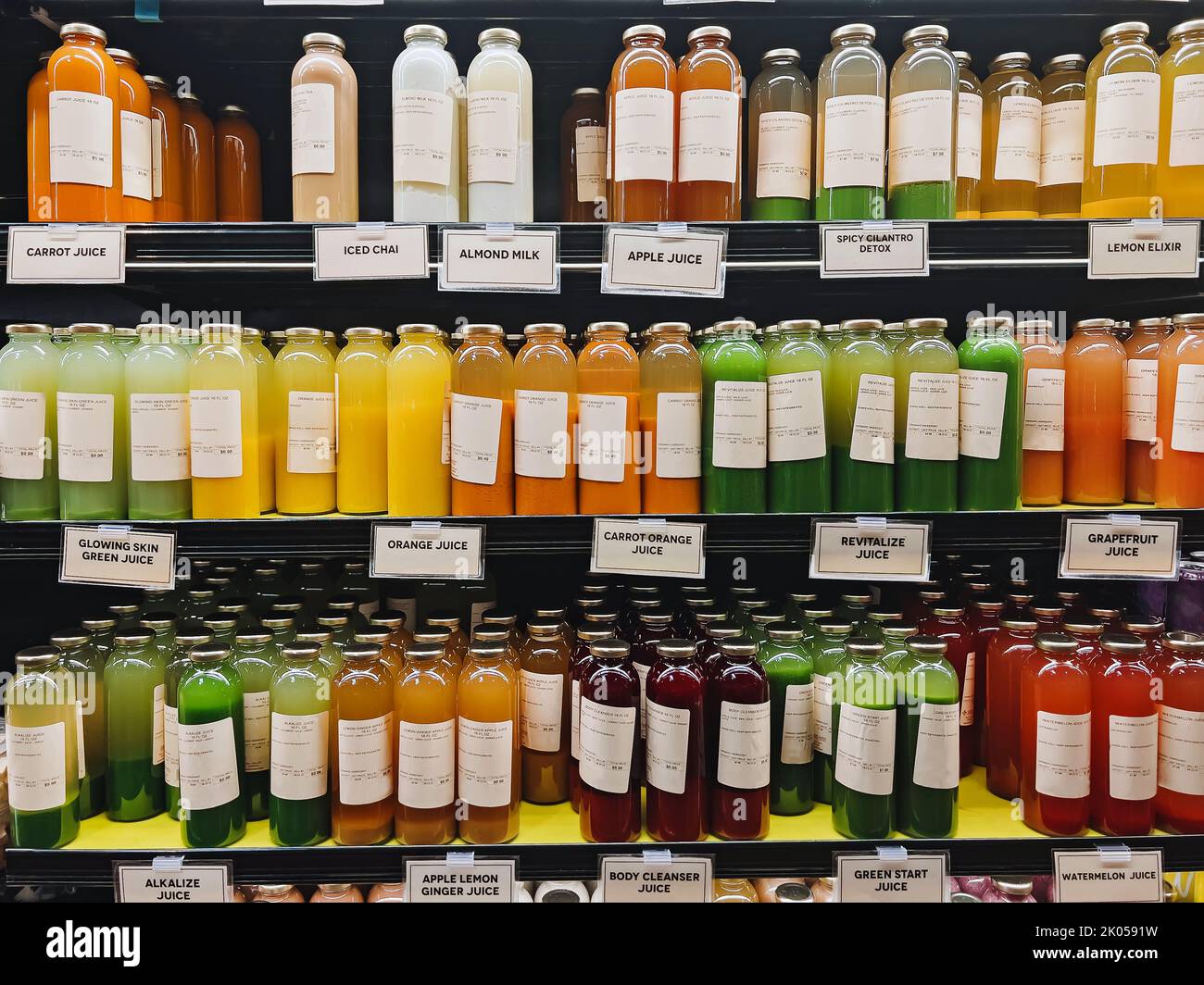 Bottles with healthy juices in the organic grocery store, healthy food and drink choice Stock