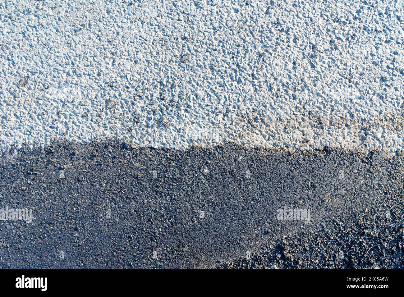 joint of an old coarse asphalt pavement with a newly laid asphalt pavement using a fine stone fraction Stock Photo