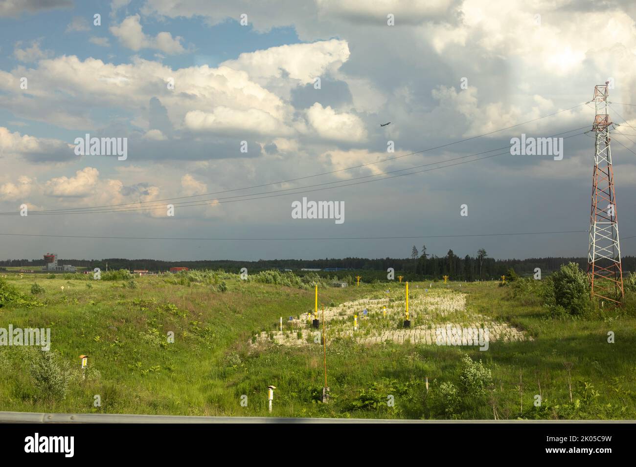 Communication tower in field. Details of radio infrastructure. Signal transmission antenna. Stock Photo