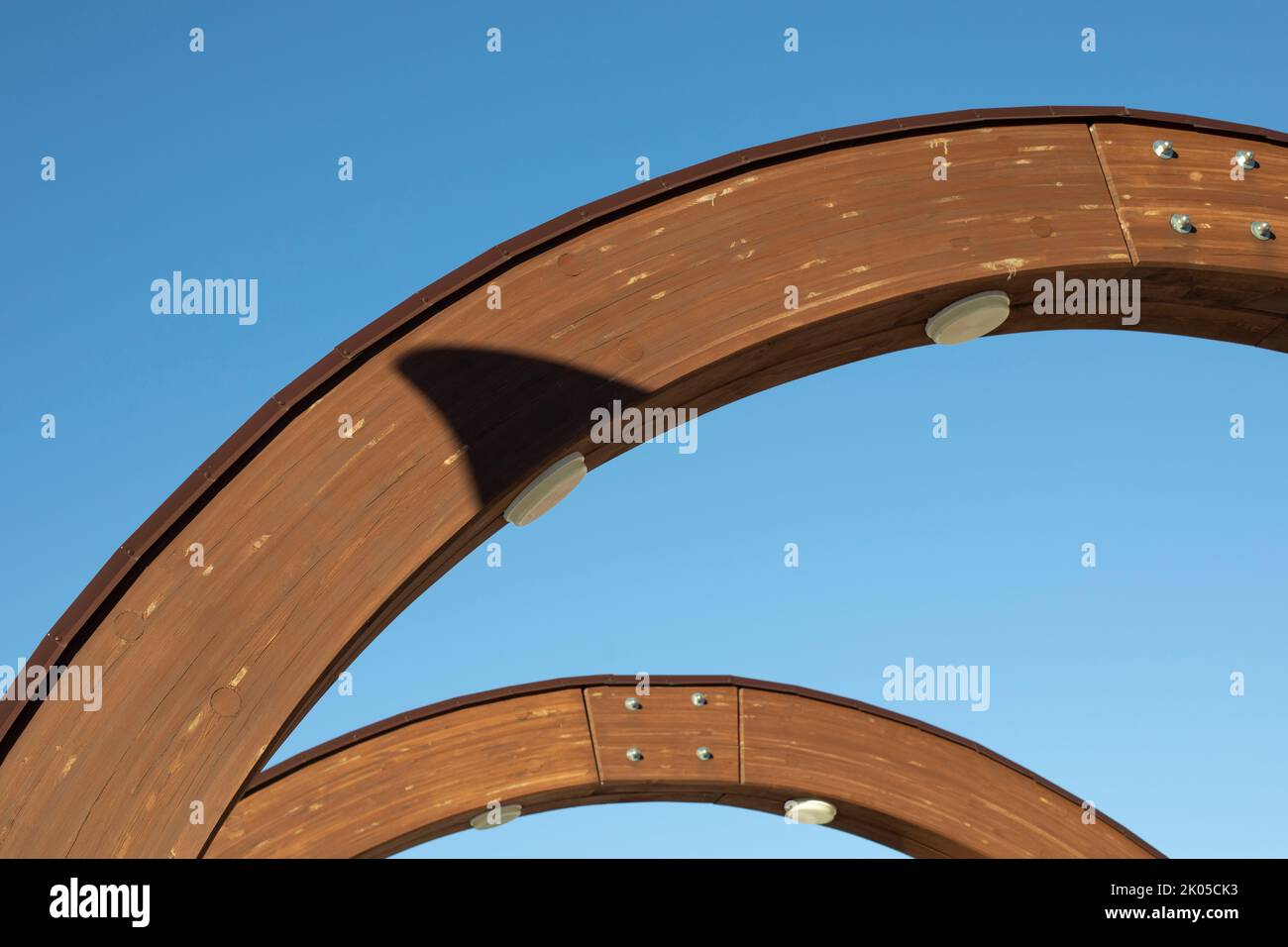 Wooden arch against sky. Architecture details. Support structure. Arc in building. Stock Photo