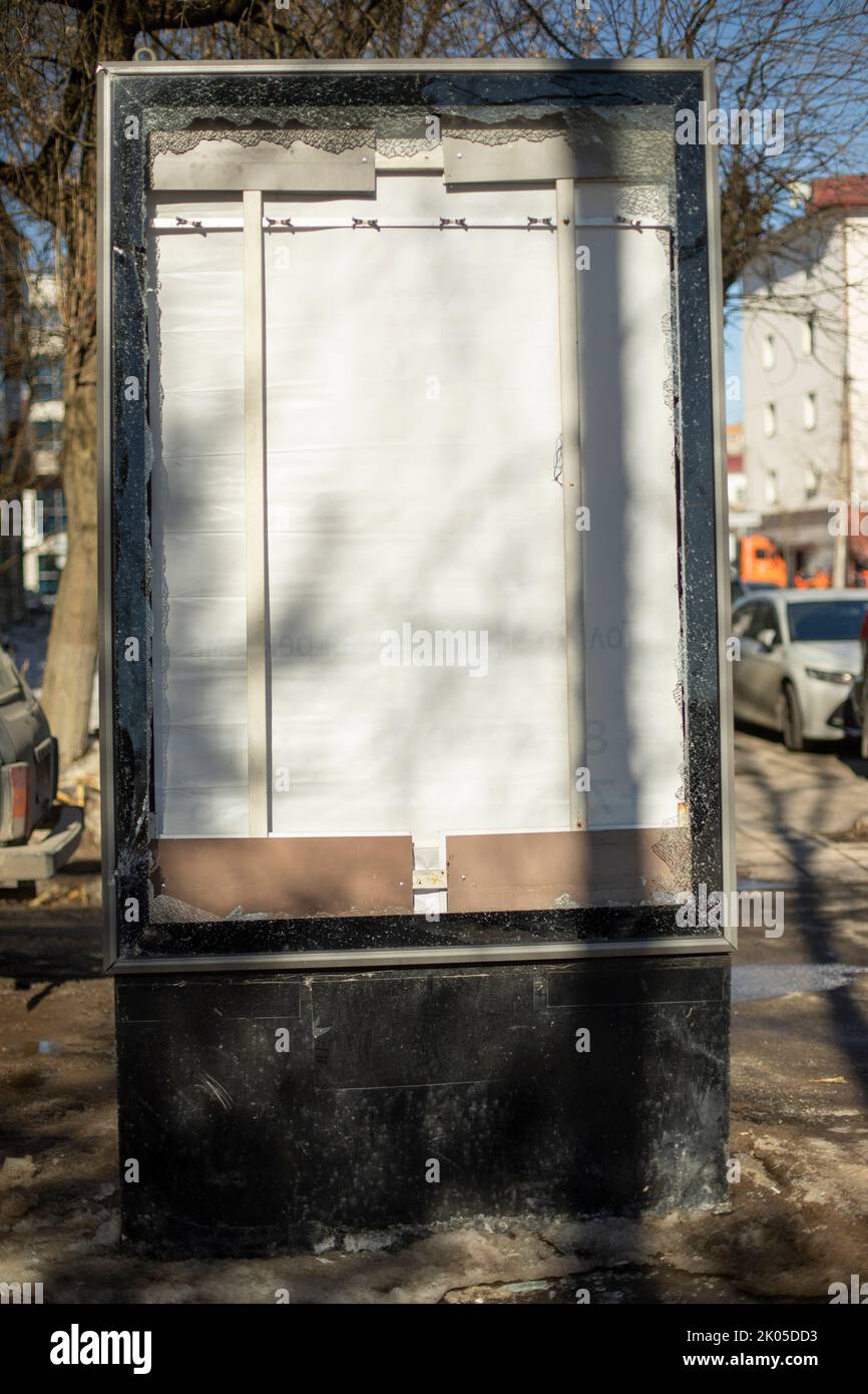 Broken billboard on street. Broken advertising space. Light boxing in city. Vandalism against structure. Stock Photo