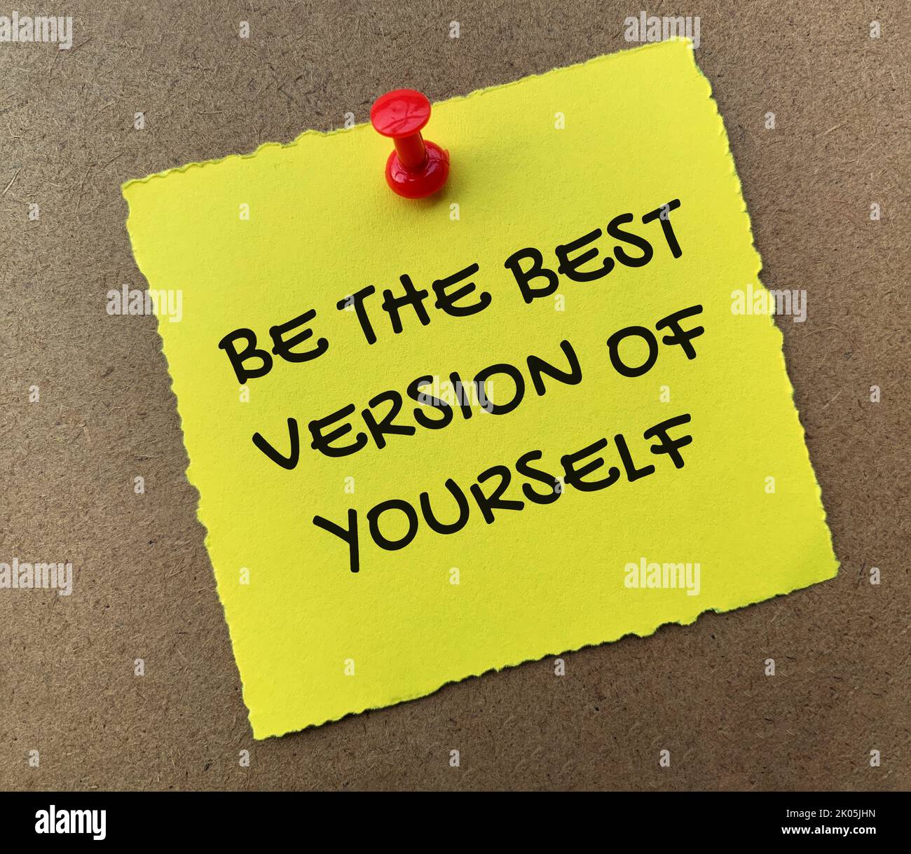 Be the best version of yourself text on yellow notepad with wooden background. Motivational concept. Stock Photo