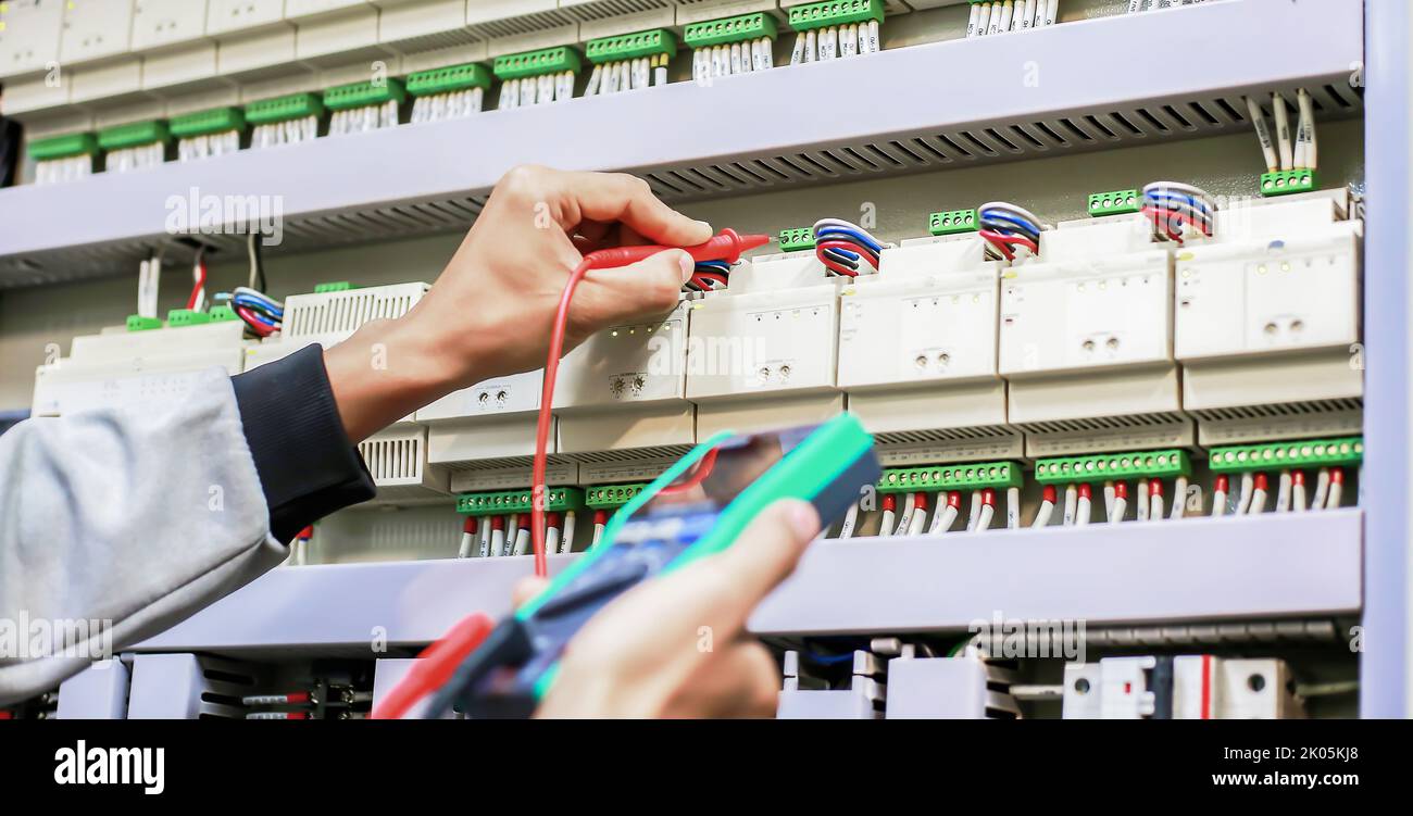 Electrician engineer work tester measuring voltage and current of power