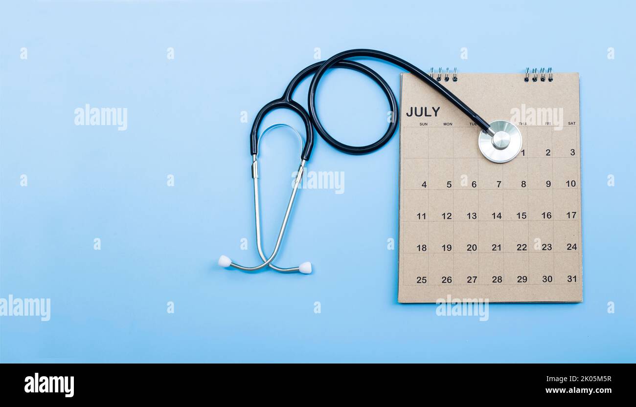 Calendar, stethoscope, on a blue background, health care concept. Stock Photo