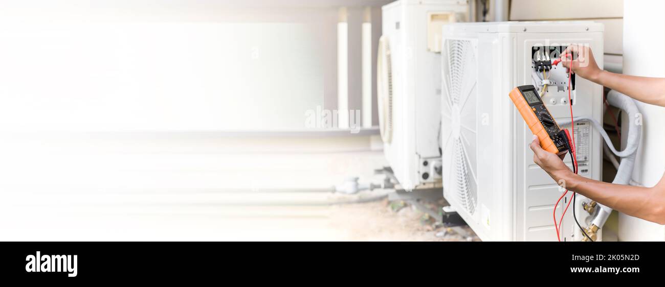 Air conditioner repairman using electricity meter to check air