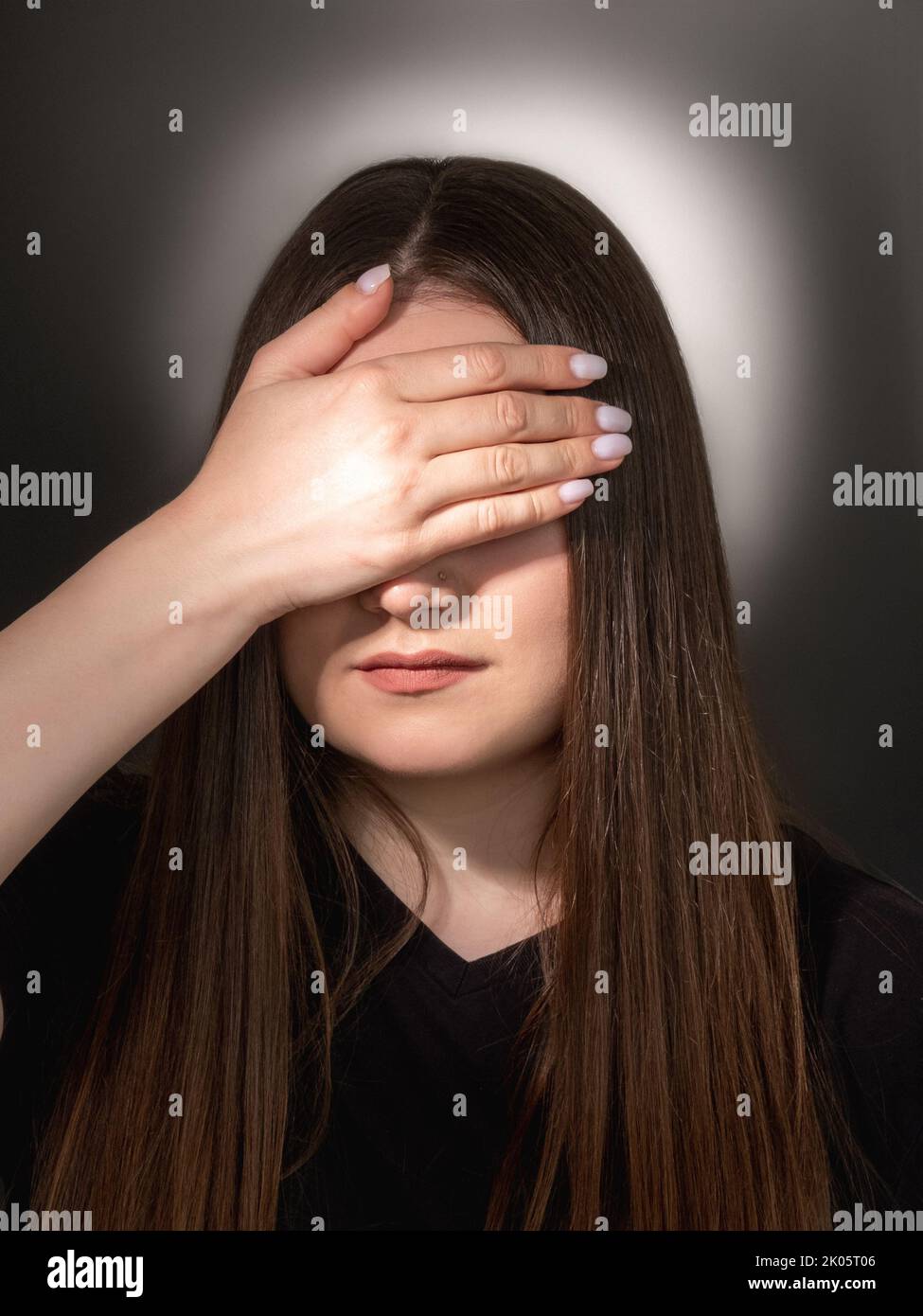 female rights family abuse woman covering eyes Stock Photo