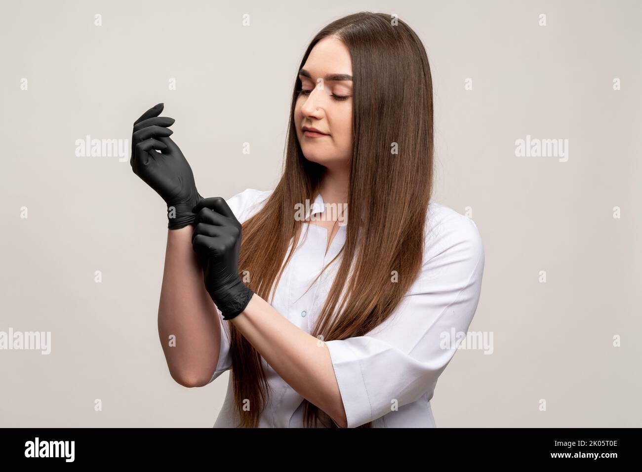 beautician portrait confident woman black gloves Stock Photo