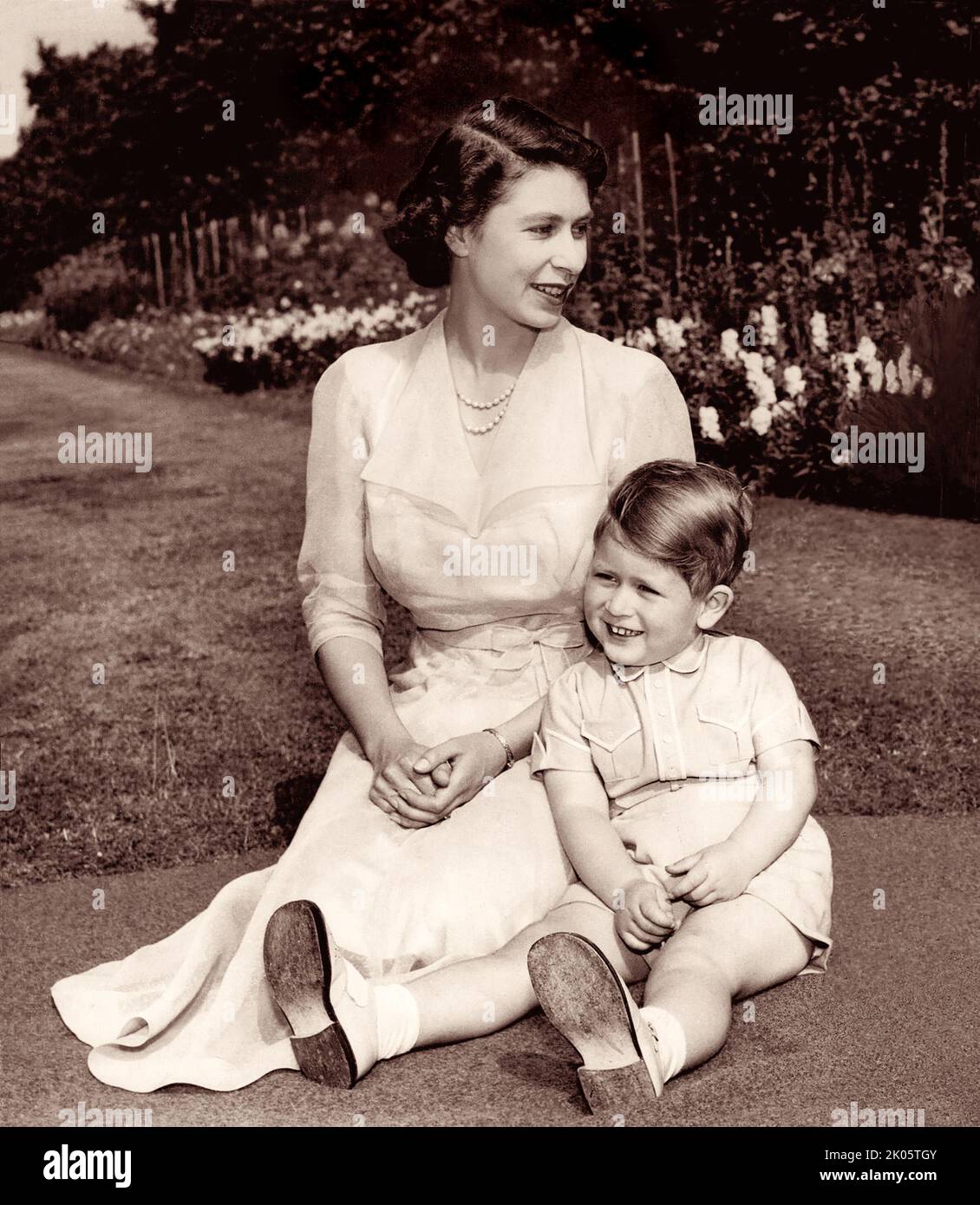 Princess Elizabeth with her son, Prince Charles, on the grounds of Clarence House, their residence in London, on August 9, 1951. Stock Photo