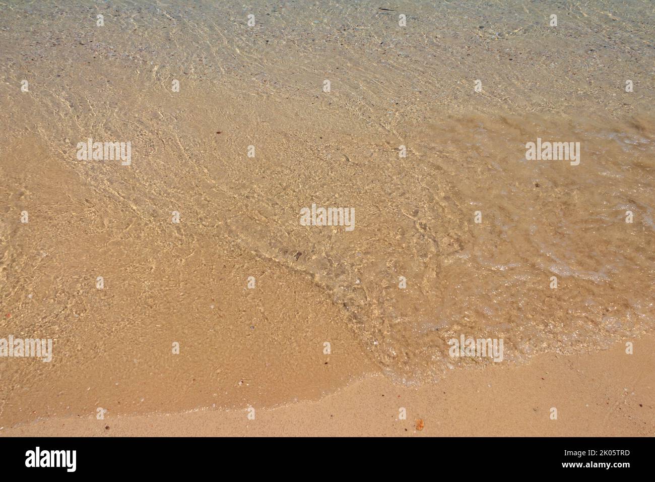Soft wave of ocean on sandy beach Stock Photo