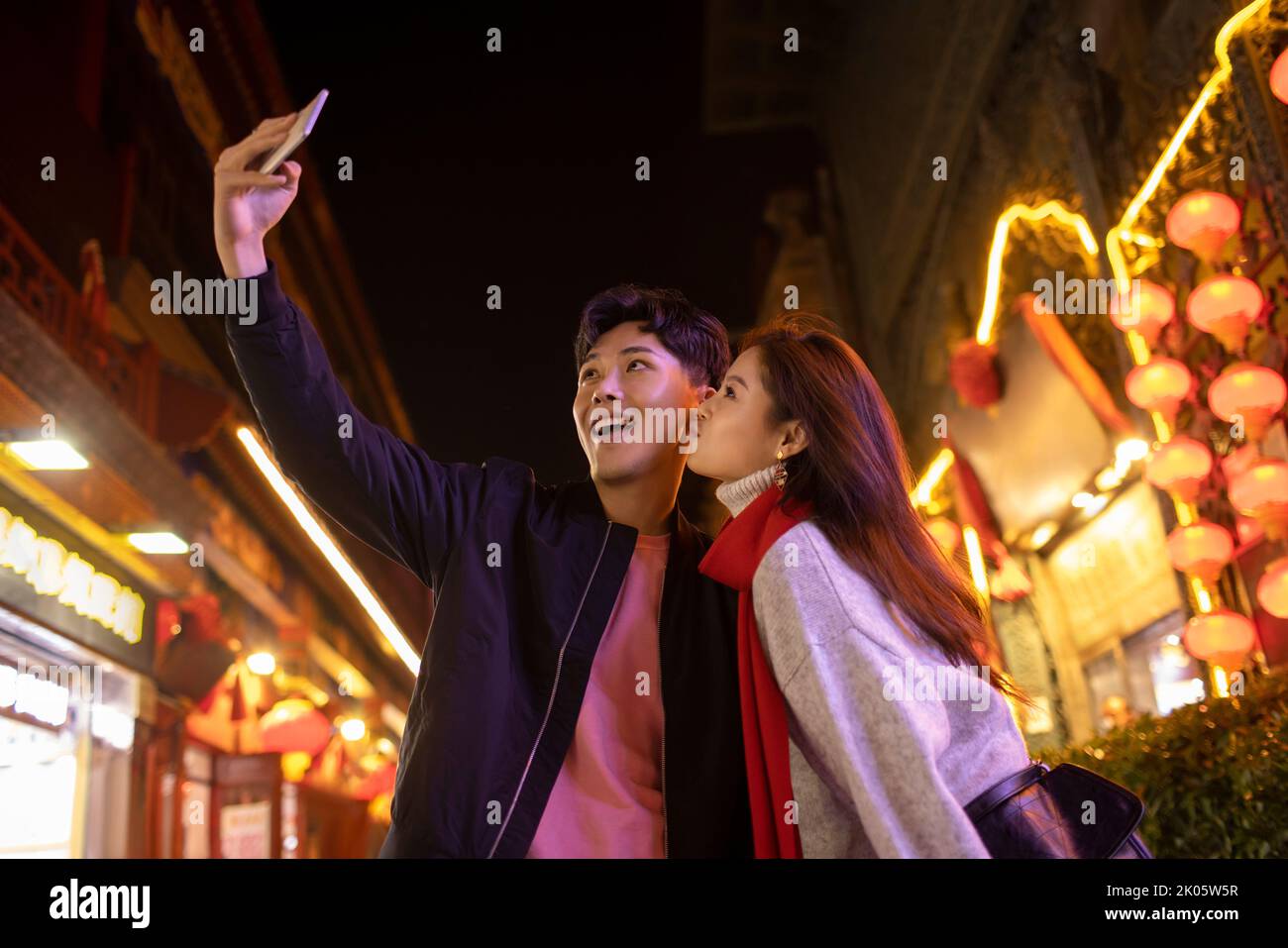 Young Chinese couple taking selfie with smart phone Stock Photo