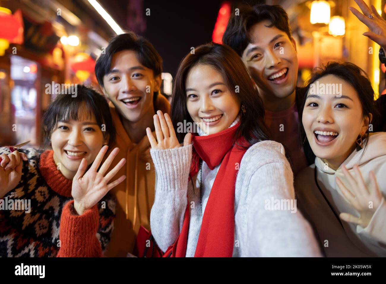 Happy young Chinese friends celebrating Chinese new year Stock Photo