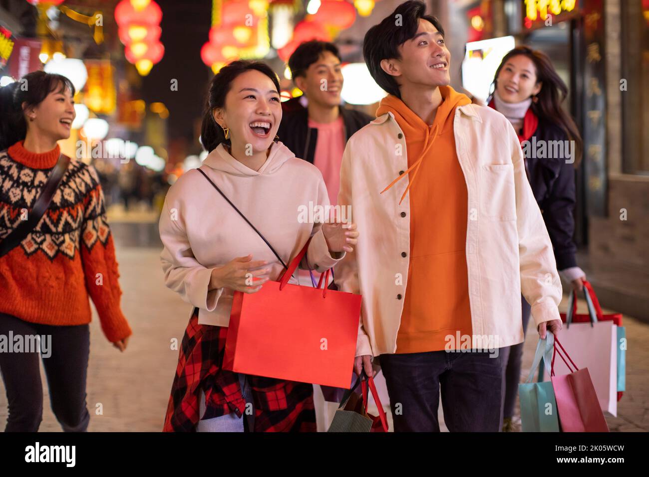 Happy young Chinese friends shopping for Chinese New Year Stock Photo
