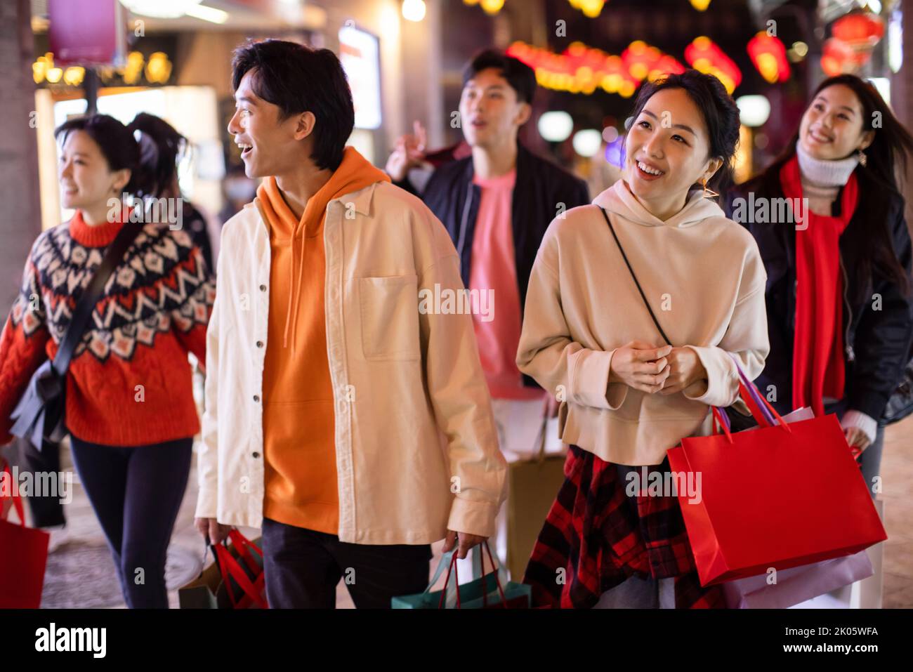 Happy young Chinese friends shopping for Chinese New Year Stock Photo