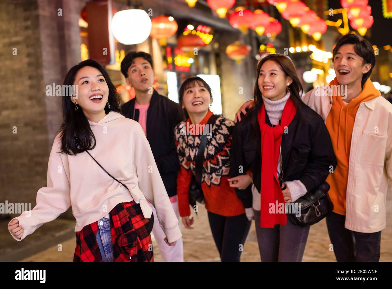 Happy young Chinese friends celebrating Chinese new year Stock Photo