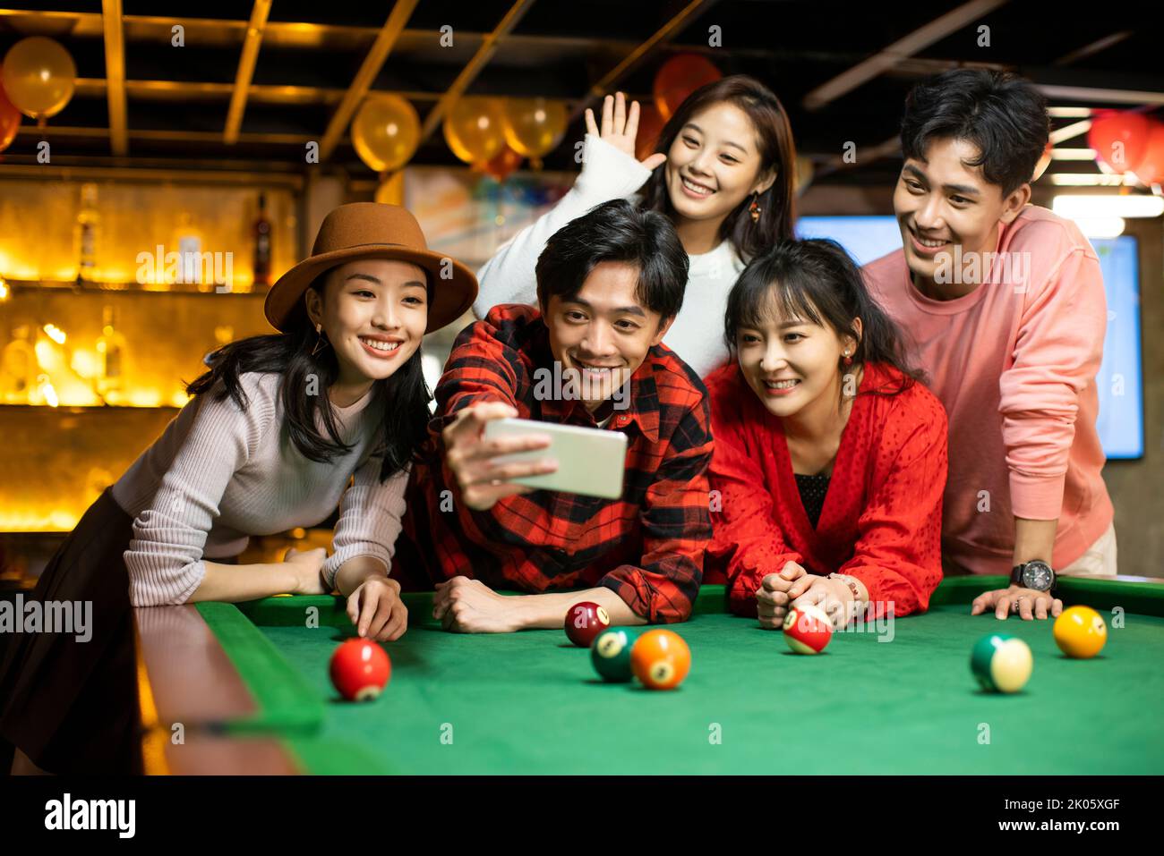 Young Chinese friends taking selfie with smart phone Stock Photo