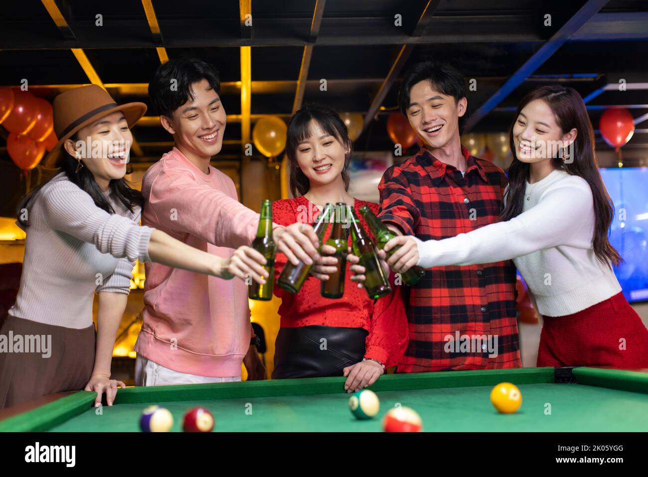Young Chinese friends toasting for Chinese new year Stock Photo