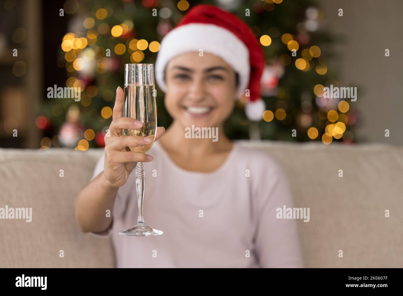 Happy young Indian woman toasting New Year wine flute Stock Photo