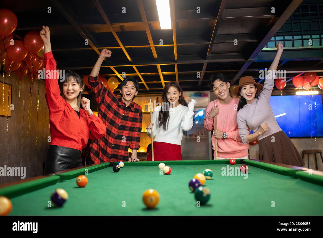 Happy young Chinese friends playing billiard together Stock Photo - Alamy