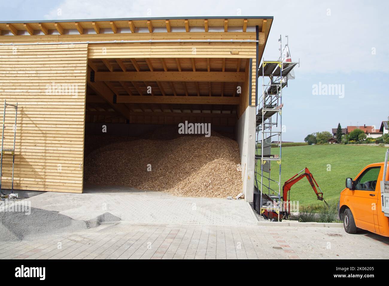 Wood chips stored in a building in southern Germany. Summer, August. Stock Photo