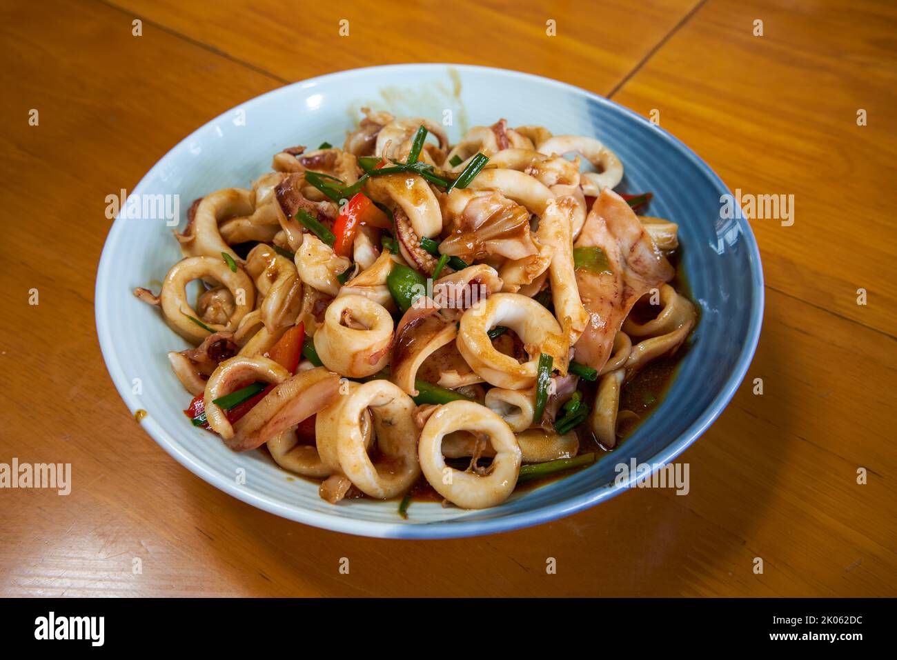 A plate of delicious and fragrant Chinese food with fried squid rings Stock Photo