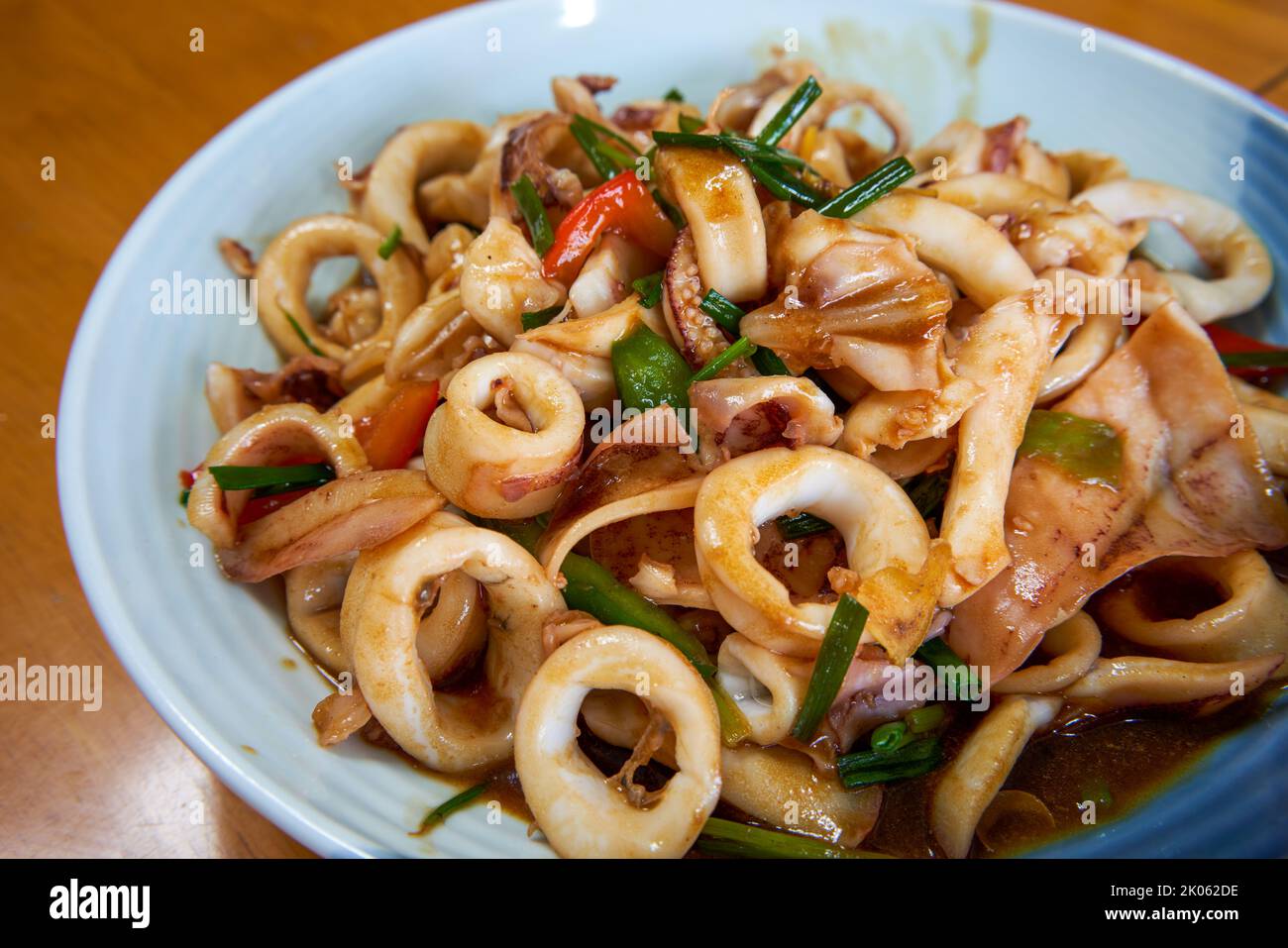 A plate of delicious and fragrant Chinese food with fried squid rings Stock Photo