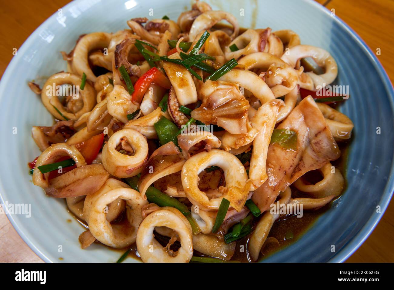 A plate of delicious and fragrant Chinese food with fried squid rings Stock Photo