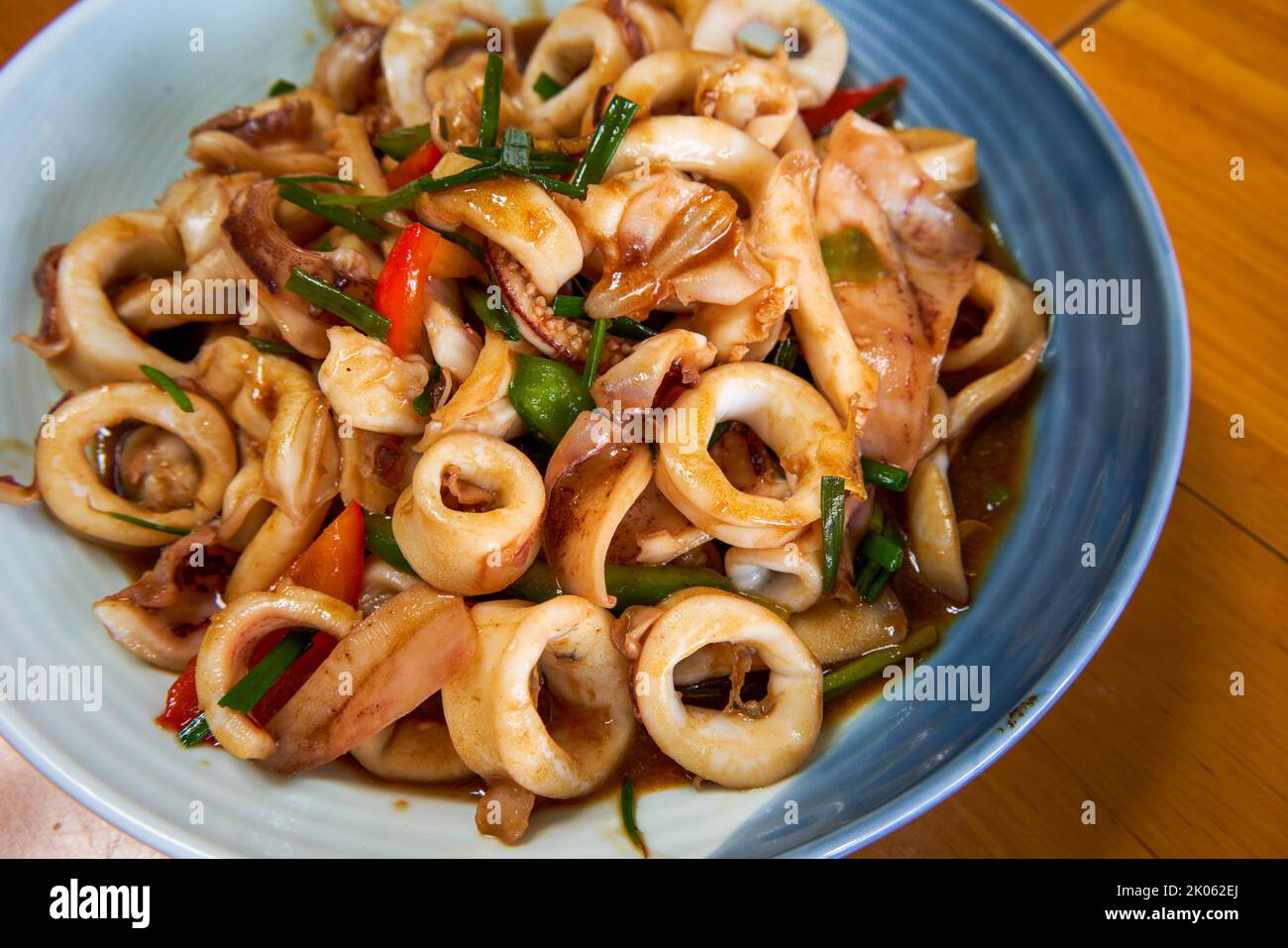 A plate of delicious and fragrant Chinese food with fried squid rings Stock Photo