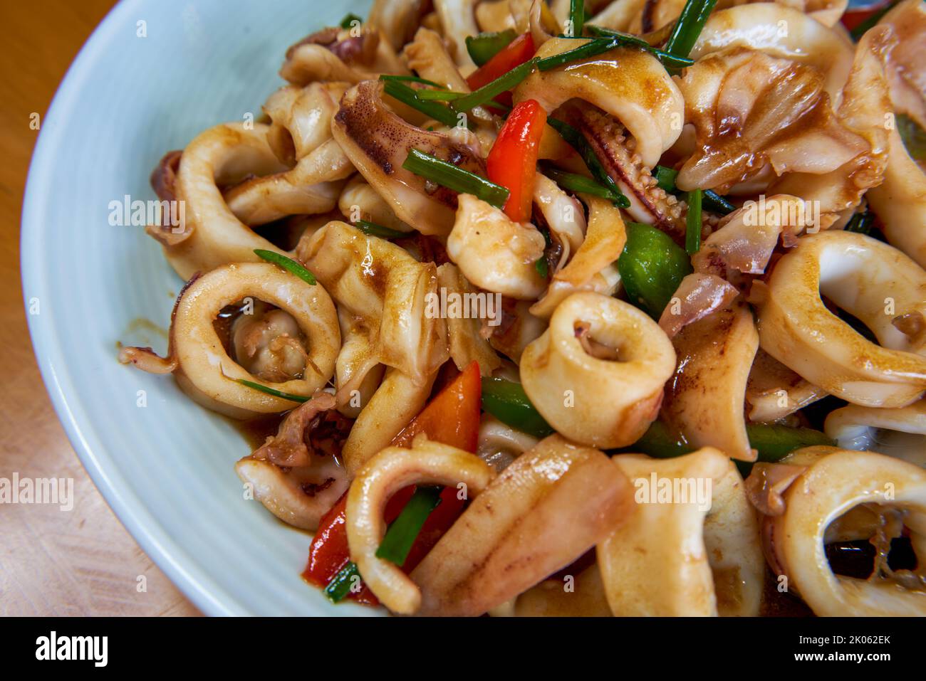 A plate of delicious and fragrant Chinese food with fried squid rings Stock Photo