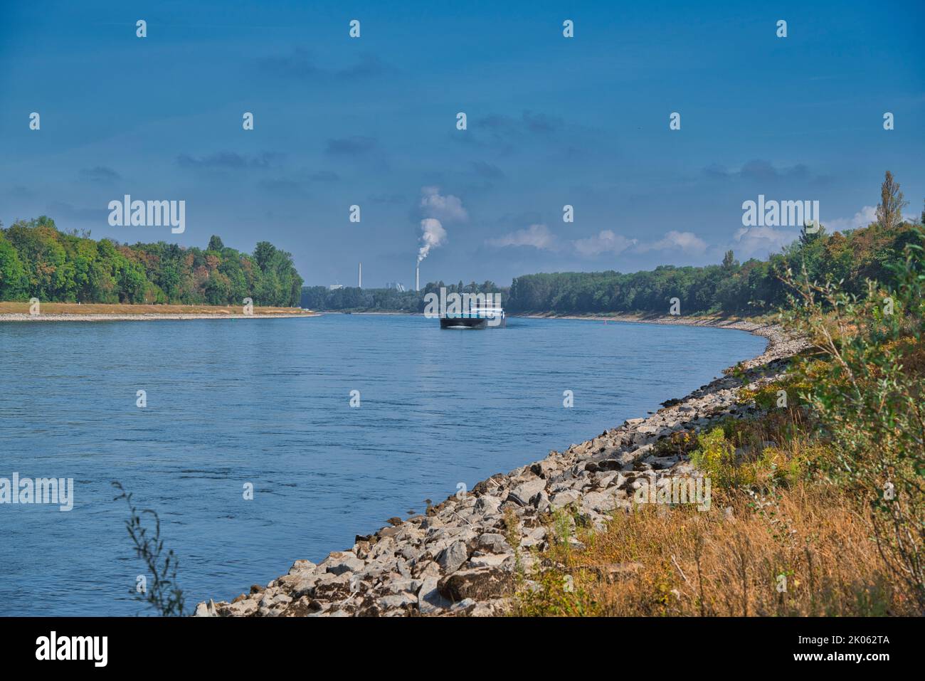 The RHEIN, GERMANY - September 2022: A beautiful shot of the cargo ship on the Rhine river near Mannheim in bright sunlight, Germany Stock Photo
