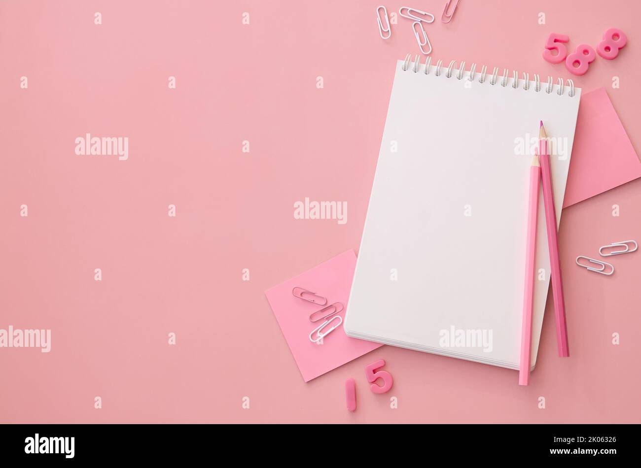 School stationery supply accessories on pink background, flat lay, copy space. Stock Photo
