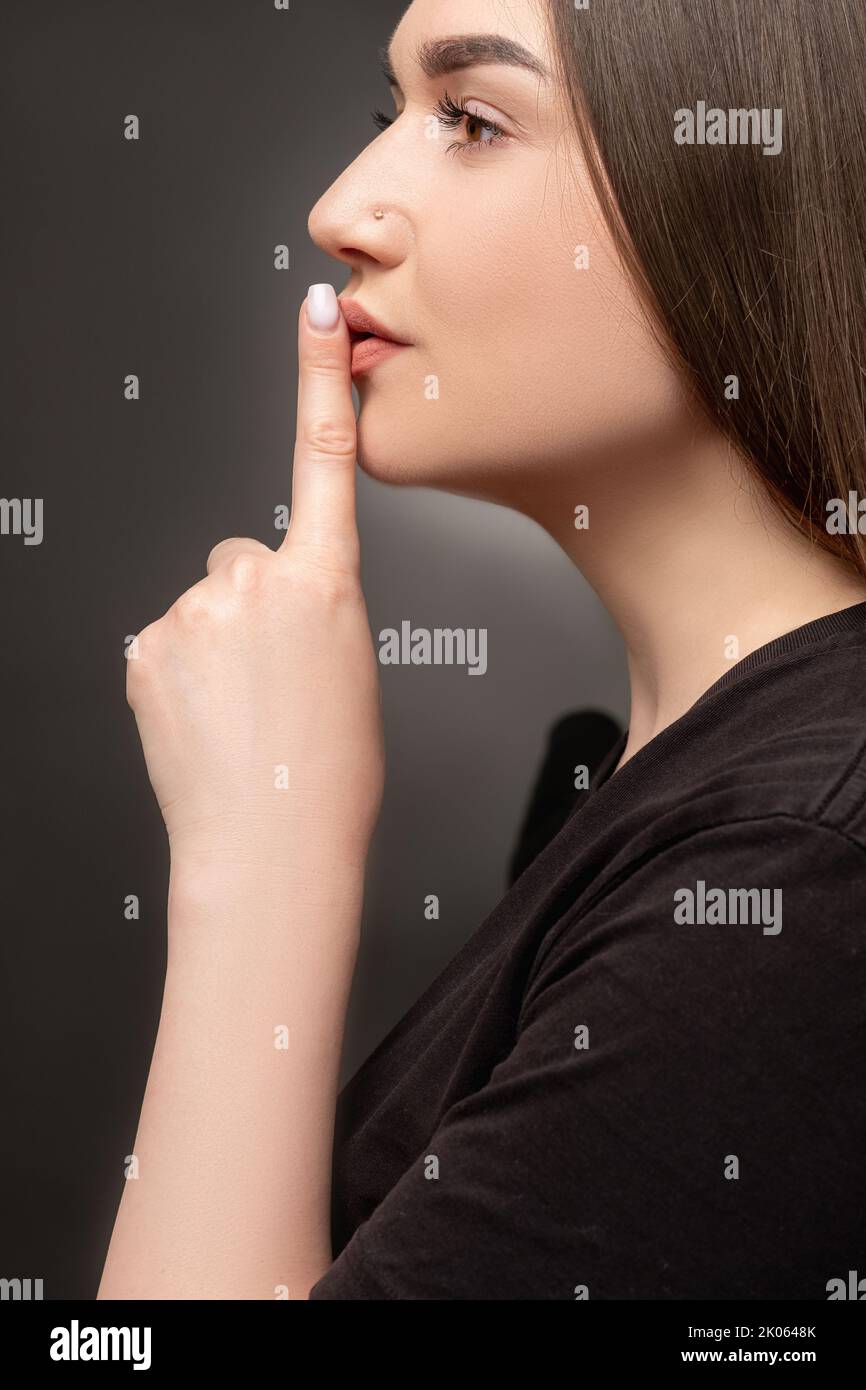 keep quiet female mystery woman showing shhh Stock Photo