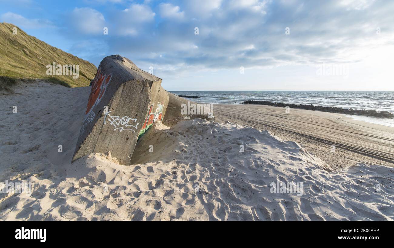 Sunken bunker on a sand beach in Denmark as part of the North Atlantic wall Stock Photo