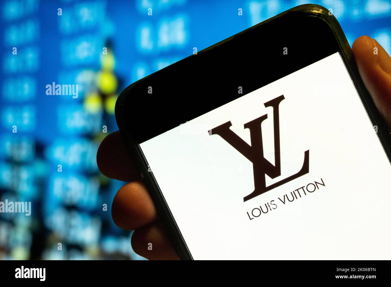 In this photo illustration, the French luxury fashion brand Louis Vuitton (LV) logo is displayed on a smartphone screen. Stock Photo