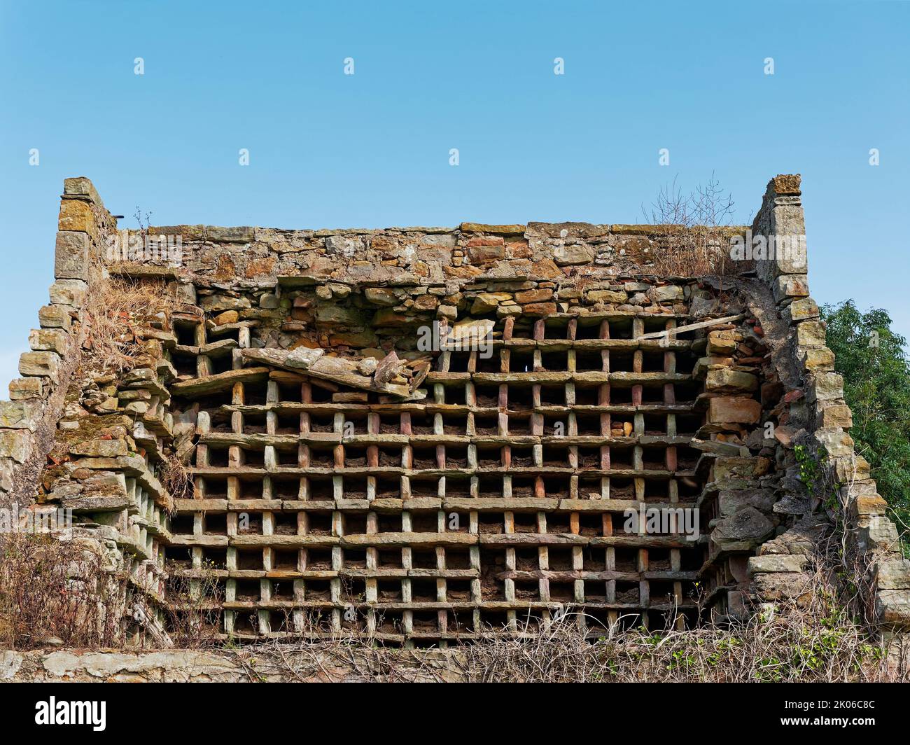 The exposed interior of an Old Dovecot or Doocot, showing the stone nesting boxes that used to host the Pigeons and Doves used as a food source. Stock Photo